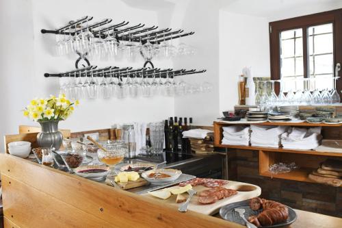 a buffet with a lot of food and wine glasses at Hiša Linhart, Hotel & Restaurant in Radovljica