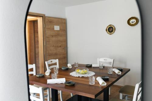 a dining room with a table and a mirror at Hiša Linhart, Hotel & Restaurant in Radovljica