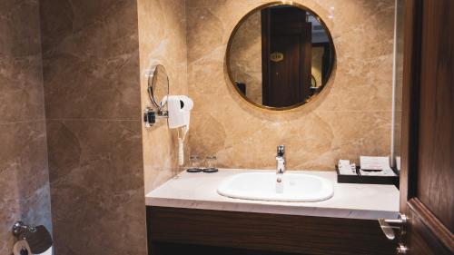 a bathroom with a sink and a mirror at Phu Cuong Hotel Ca Mau in Cà Mau