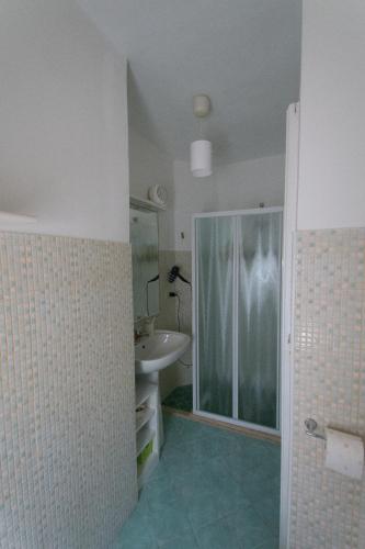 a bathroom with a sink and a glass shower at Casa RoSiLù in Monopoli
