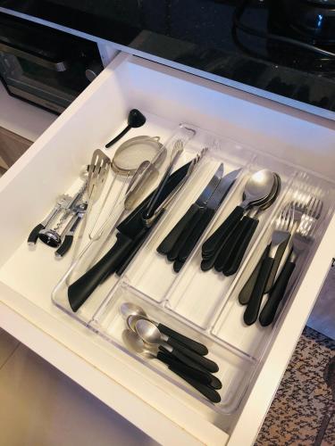 a drawer filled with silver utensils in a kitchen at Vista do Vale! 400 metros da Rua Coberta - Acomoda até 4 hóspedes in Gramado