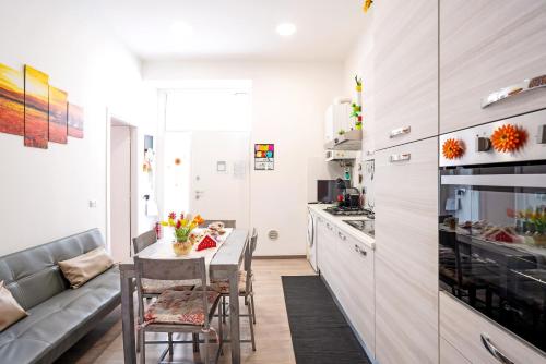 a kitchen with a table and chairs and a couch at Casa Aurora in La Spezia