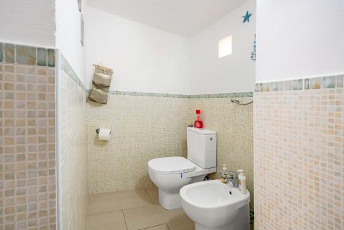 a bathroom with a white toilet and a sink at Casa Aurora in La Spezia