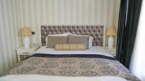 a bedroom with a large bed with two night stands at Salonika Suites in Oludeniz
