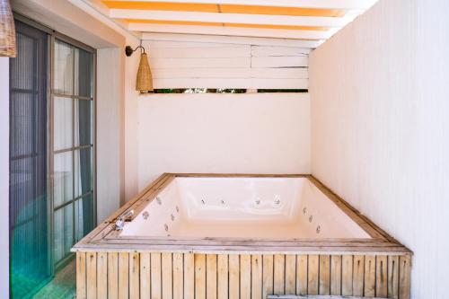 a jacuzzi tub in a room with a window at Salonika Suites in Oludeniz