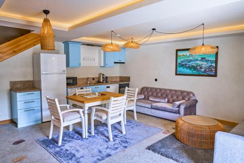 a kitchen and living room with a table and a couch at Salonika Suites in Oludeniz