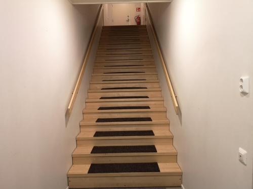 a stairway in a room with wooden steps at The HOME of Hiisi in Nummela