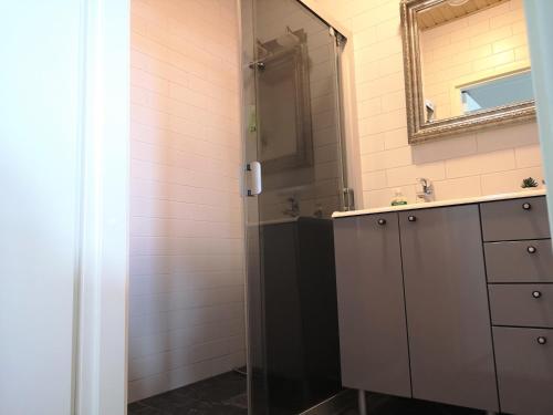a bathroom with a sink and a mirror at The HOME of Hiisi in Nummela