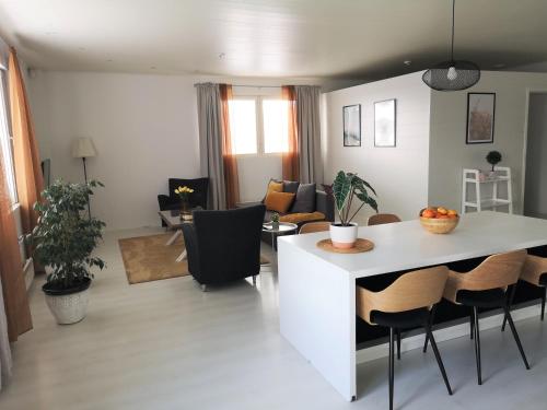 a kitchen and living room with a table and chairs at The HOME of Hiisi in Nummela