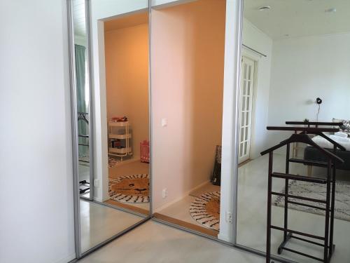 a sliding glass door in a room with a mirror at The HOME of Hiisi in Nummela