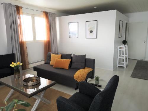 a living room with a couch and a table at The HOME of Hiisi in Nummela