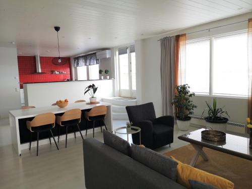 a living room with a couch and a table at The HOME of Hiisi in Nummela