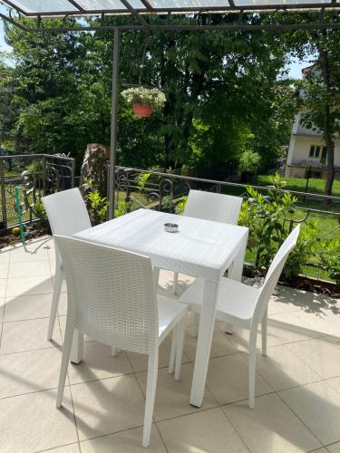a white table and chairs on a patio at Green garden in Žarkovo