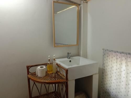een badkamer met een wastafel en een spiegel bij O'hamok family in Battambang