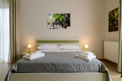 a bedroom with a bed with two towels on it at Bee Happy - Bed and Breakfast in Zafferana Etnea