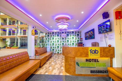 a lobby of a hotel with couches and a bar at FabEscape SK Studios With Pool & GYM, Arpora in Arpora