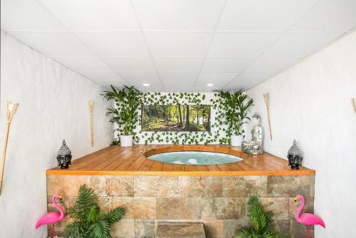 a hot tub in a room with pink flamingos at Casa Mirajanda in Vejer de la Frontera