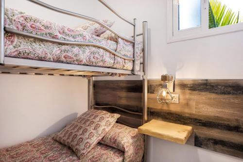 a room with a bunk bed and a chair at Casa Mirajanda in Vejer de la Frontera