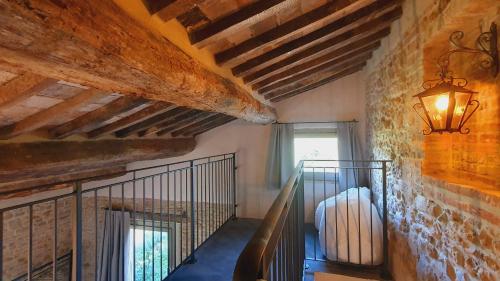 a room with a staircase in a building with a lamp at Stelle di Monte in Montepulciano