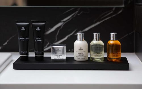 a group of four bottles ofmetics sitting on a table at Radisson Collection Hotel, Warsaw in Warsaw