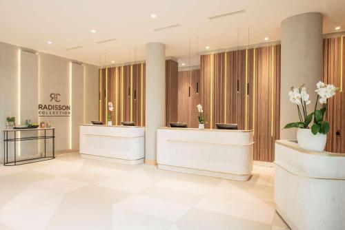 a lobby of a dermatologist appointment room with flowers at Radisson Collection Hotel, Warsaw in Warsaw