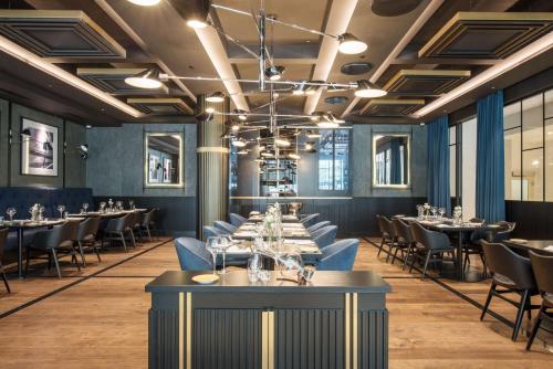 a dining room with tables and chairs at Radisson Collection Hotel, Warsaw in Warsaw