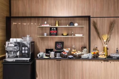 a kitchen with a counter with a coffee maker at Radisson Collection Hotel, Warsaw in Warsaw