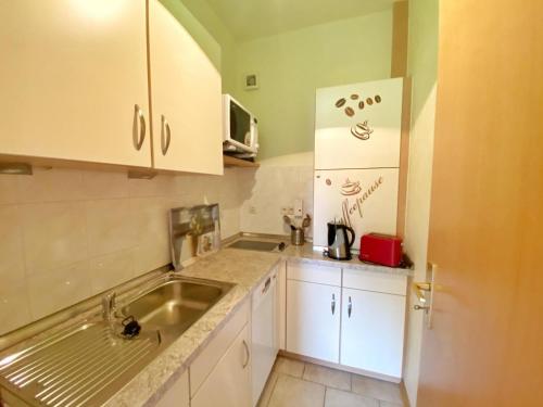 a small kitchen with a sink and a refrigerator at Ferienwohnungen Stadtmitte in Sassnitz