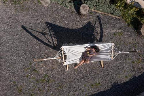 a person sitting on a chair with an umbrella at The Olive Yard in Gythio