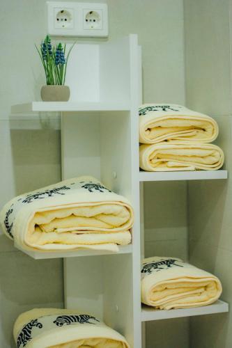 a room with shelves filled with lots of towels at Rakoczi apartman 2 in Odorheiu Secuiesc
