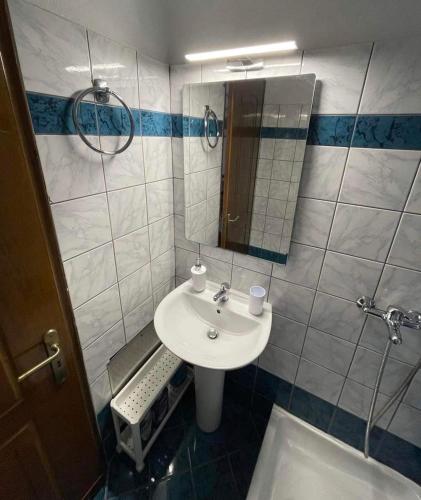 a bathroom with a sink and a mirror at ALEKA KOTSI ROOMS 2 in Igoumenitsa