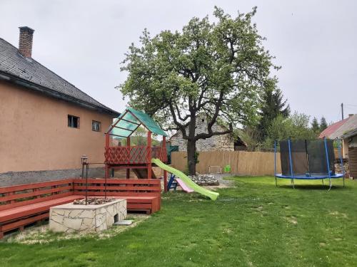 a park with a playground with a bench and a slide at Sweet Home Apartman Szilvásvárad in Szilvásvárad
