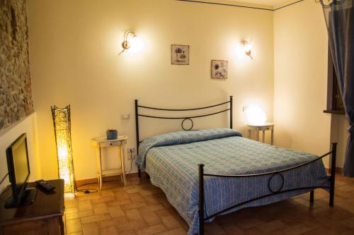 a bedroom with a bed with a blue comforter at Room in Holiday house - Green Ortensia - Amazing apartment in Farmhouse in Chiesina Uzzanese