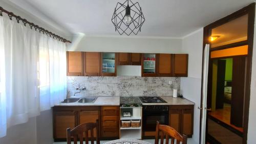 a kitchen with a sink and a stove top oven at Apartment City Heart in Trebinje