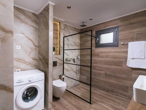 a bathroom with a washing machine and a shower at Kambos Nature View Villa in Périon