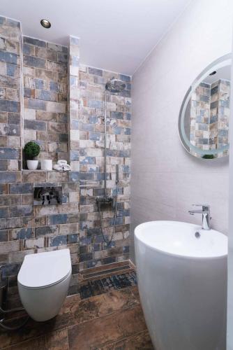 a bathroom with a white toilet and a mirror at Kambos Nature View Villa in Périon