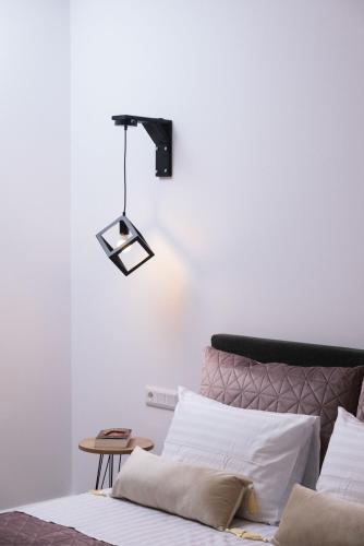 a bedroom with a bed with a light above it at Kambos Nature View Villa in Périon