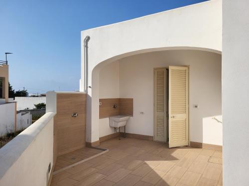 a balcony with a toilet and a door on a building at Appartamento Le Sorgenti in Torre Vado