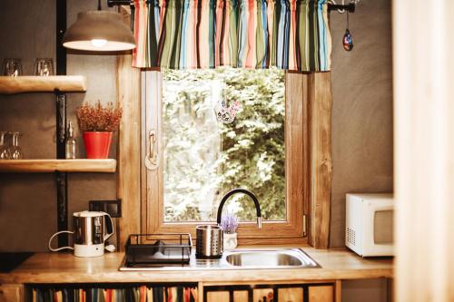 a kitchen with a sink and a window at UROCZY DOMEK in Brenna