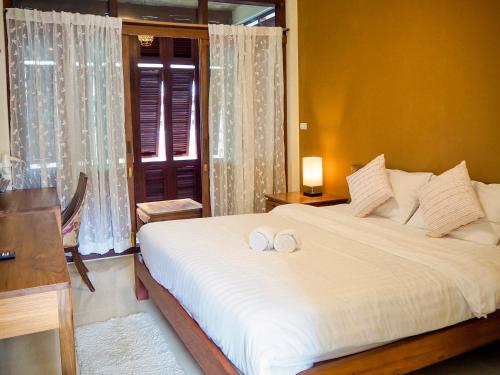 Postel nebo postele na pokoji v ubytování Baan Dan Ta Wan Nuea
