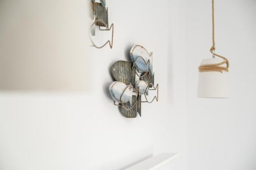 a group of pots and pans hanging on a wall at Cyano Hotel in Plakias