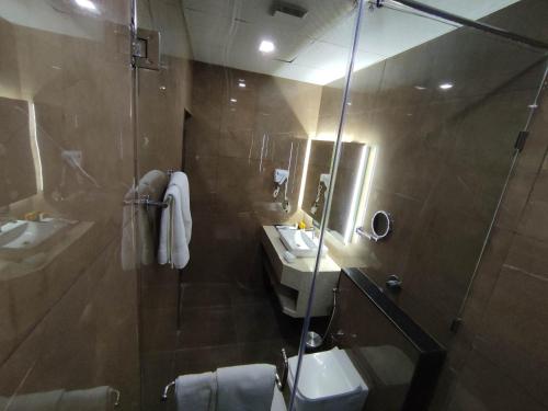 a bathroom with a shower and a sink and a mirror at SILVER CLOUD in Nandigunda