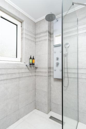 a bathroom with a shower with a glass door at Cyano Hotel in Plakias