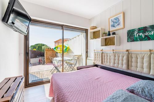 a bedroom with a bed and a balcony at Chez Pierrot in Bandol