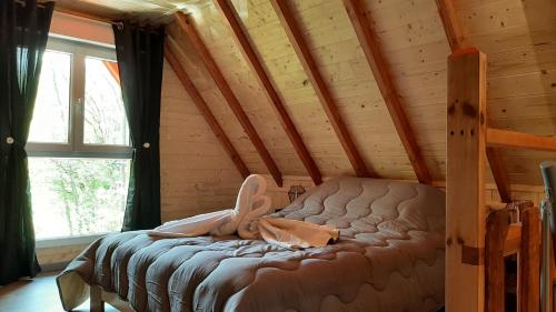a bedroom with a bed in a log cabin at Le Domaine du Châtelet in Ferdrupt