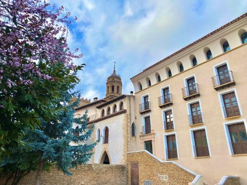 a building with a tower on top of it at Hotel Palacio Matutano-Daudén in La Iglesuela del Cid
