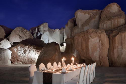 a table in a cave with candles on it at Al Ahsa InterContinental by IHG in Al Ahsa