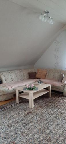a living room with a couch and a coffee table at Ferienwohnung Gutowski in Andernach