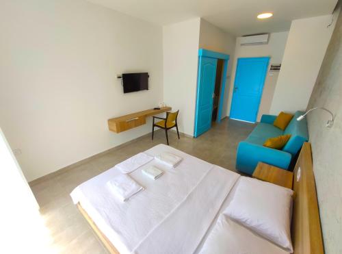 a small room with a bed and a couch at OASİS AT AYFİLON in Rizokarpaso