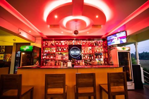 a bar in a restaurant with a lot of alcohol at The Woodside Inn in Benaulim
